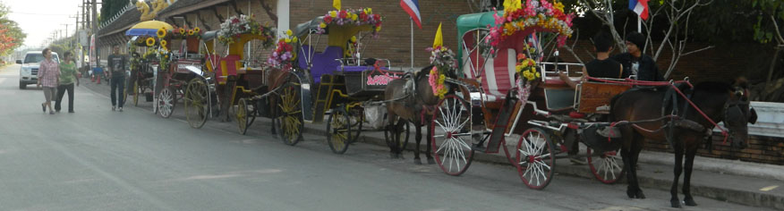 Horse-drawn carriages waiting outside Wat Phra That Lampang Luang